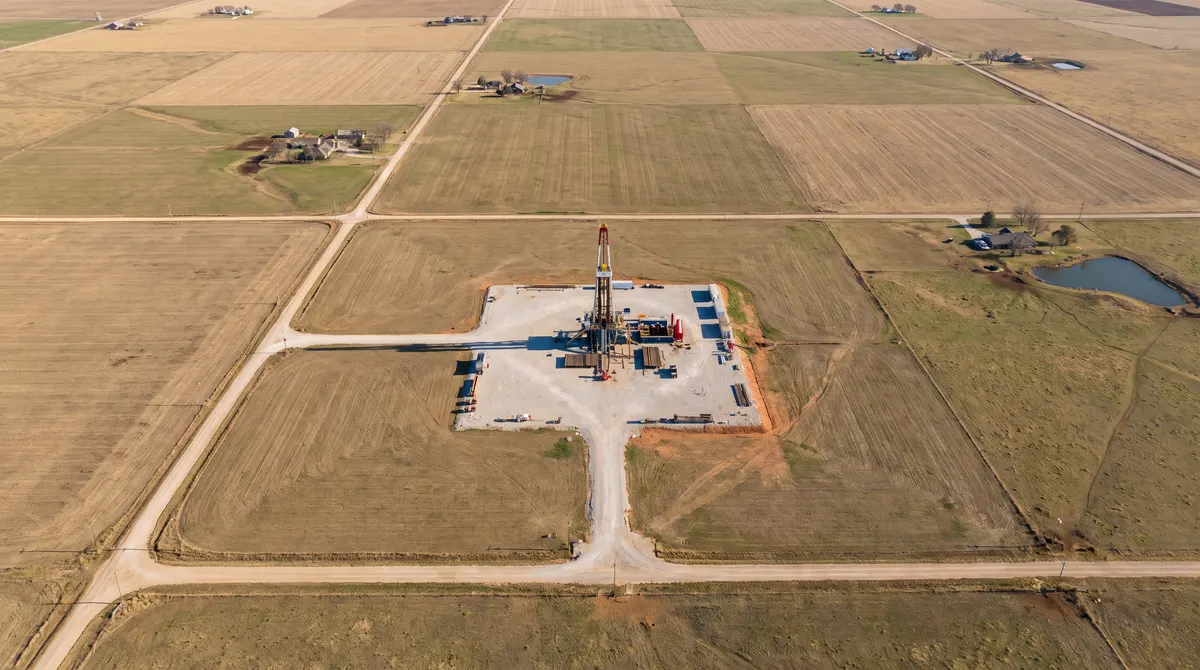 Aerial view of a horizontal drilling pad on farmland divided by section-line roads